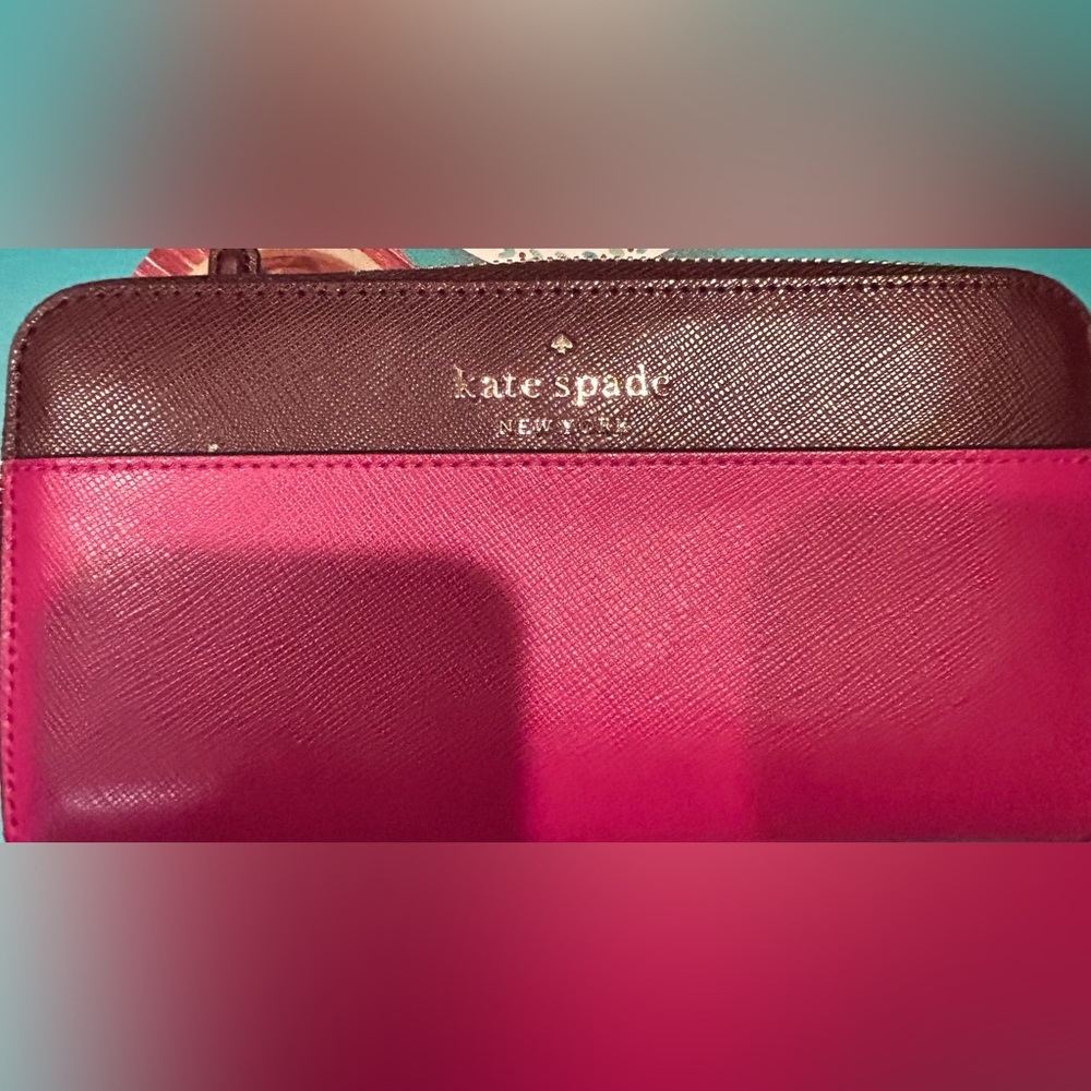Kate Spade Stacey color block large continental wallet in pink and maroon.